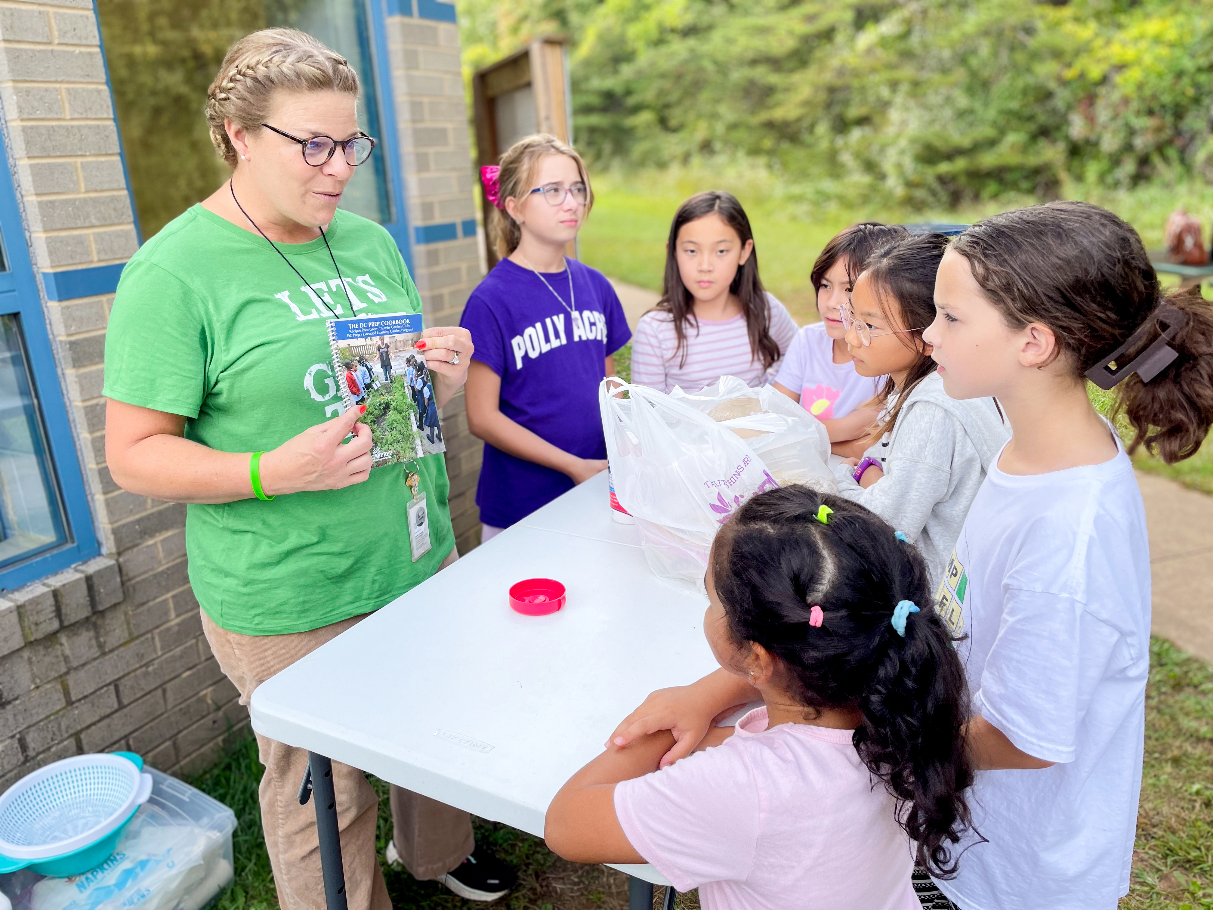 Willow Springs STEAM teacher Carley Fisher-Maltese teaches students how to cook with fresh vegetables and herbs in the school's Garden Club.